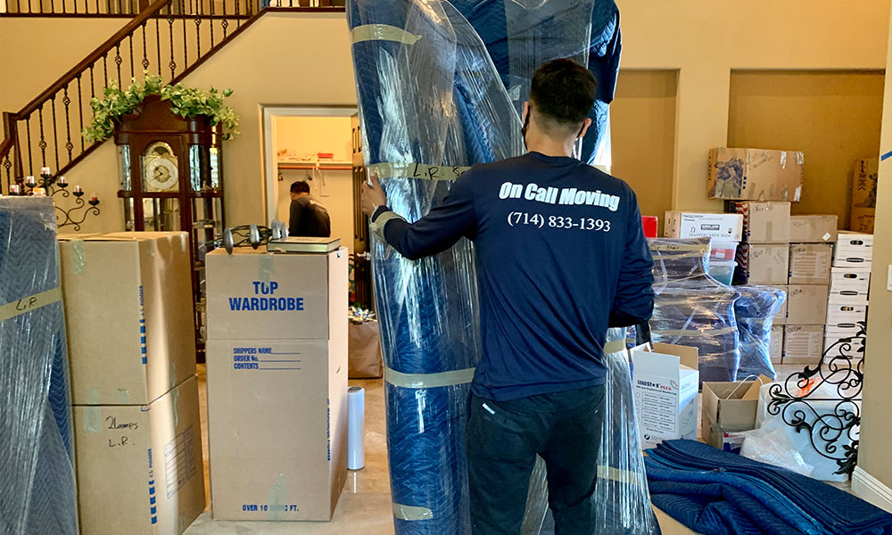 One of our movers wrapping a sofa.